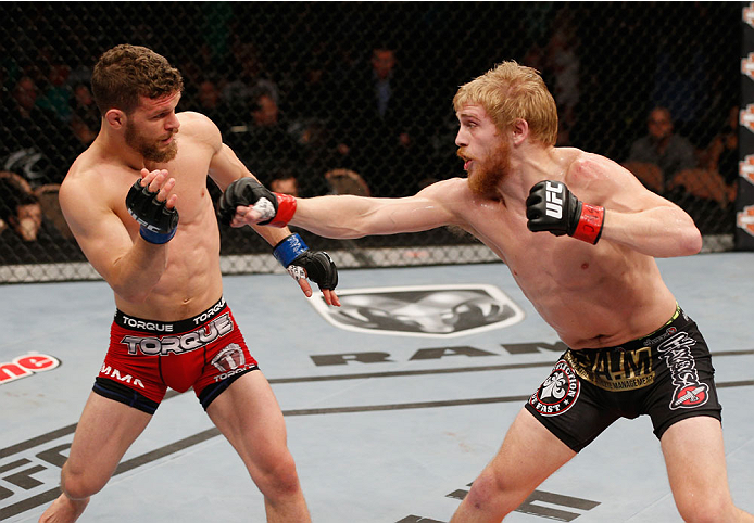 LAS VEGAS, NV - JULY 06: (R-L) Justin Scoggins punches Dustin Ortiz in their flyweight fight during the Ultimate Fighter Finale inside the Mandalay Bay Events Center on July 6, 2014 in Las Vegas, Nevada. (Photo by Josh Hedges/Zuffa LLC/Zuffa LLC via Get