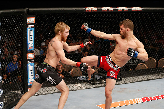 LAS VEGAS, NV - JULY 06: (R-L) Dustin Ortiz kicks Justin Scoggins in their flyweight fight during the Ultimate Fighter Finale inside the Mandalay Bay Events Center on July 6, 2014 in Las Vegas, Nevada. (Photo by Josh Hedges/Zuffa LLC/Zuffa LLC via Getty