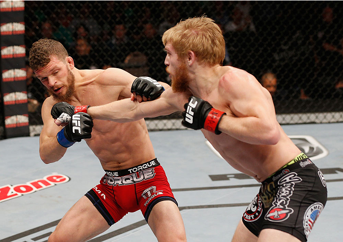 LAS VEGAS, NV - JULY 06:  (R-L) Justin Scoggins punches Dustin Ortiz in their flyweight fight during the Ultimate Fighter Finale inside the Mandalay Bay Events Center on July 6, 2014 in Las Vegas, Nevada.  (Photo by Josh Hedges/Zuffa LLC/Zuffa LLC via Get