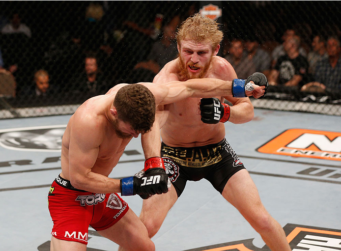 LAS VEGAS, NV - JULY 06:  (L-R) Dustin Oritz punches Justin Scoggins in their flyweight fight during the Ultimate Fighter Finale inside the Mandalay Bay Events Center on July 6, 2014 in Las Vegas, Nevada.  (Photo by Josh Hedges/Zuffa LLC/Zuffa LLC via Get