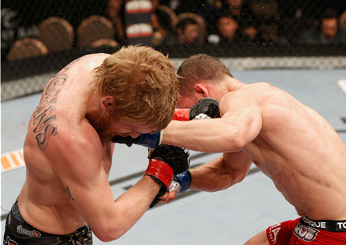 LAS VEGAS, NV - JULY 06:  (L-R) Justin Scoggins and Dustin Ortiz exchange punches in their flyweight fight during the Ultimate Fighter Finale inside the Mandalay Bay Events Center on July 6, 2014 in Las Vegas, Nevada.  (Photo by Josh Hedges/Zuffa LLC/Zuff