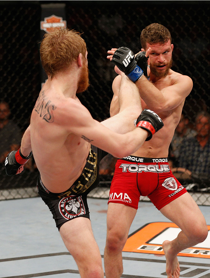 LAS VEGAS, NV - JULY 06: (L-R) Justin Scoggins kicks Dustin Ortiz in their flyweight fight during the Ultimate Fighter Finale inside the Mandalay Bay Events Center on July 6, 2014 in Las Vegas, Nevada. (Photo by Josh Hedges/Zuffa LLC/Zuffa LLC via Getty