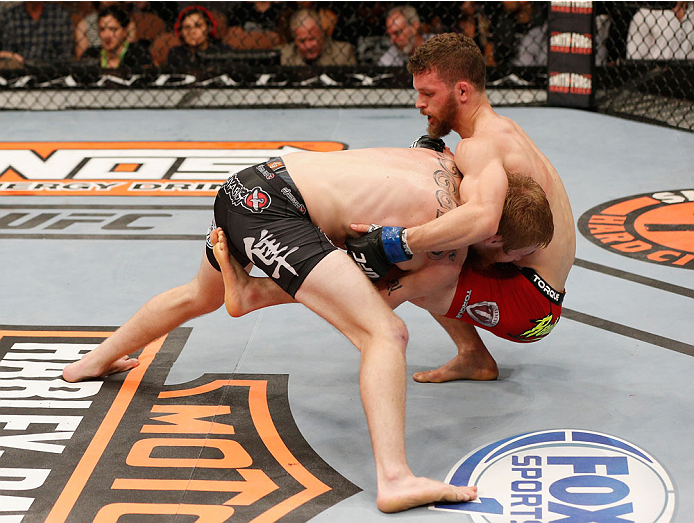 LAS VEGAS, NV - JULY 06:  (L-R) Justin Scoggins takes down Dustin Ortiz in their flyweight fight during the Ultimate Fighter Finale inside the Mandalay Bay Events Center on July 6, 2014 in Las Vegas, Nevada.  (Photo by Josh Hedges/Zuffa LLC/Zuffa LLC via 