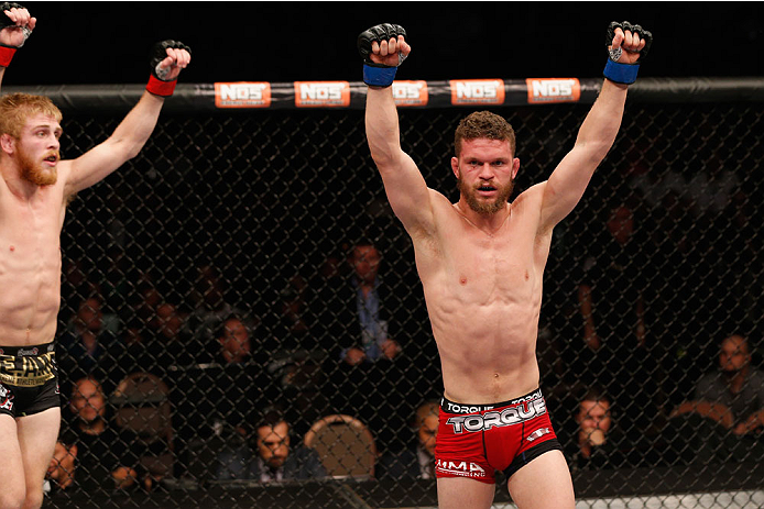 LAS VEGAS, NV - JULY 06:  (L-R) Justin Scoggin and Dustin Ortiz raise their hands after in their flyweight fight during the Ultimate Fighter Finale inside the Mandalay Bay Events Center on July 6, 2014 in Las Vegas, Nevada.  (Photo by Josh Hedges/Zuffa LL