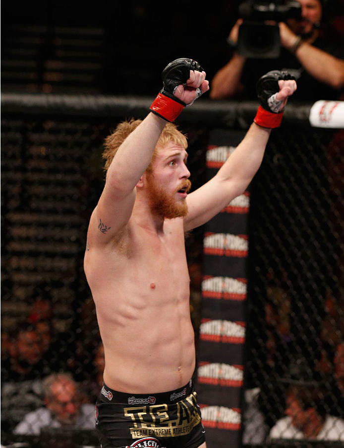 LAS VEGAS, NV - JULY 06: Justin Scoggins raises his hands after his fight with Dustin Oritz in their flyweight fight during the Ultimate Fighter Finale inside the Mandalay Bay Events Center on July 6, 2014 in Las Vegas, Nevada. (Photo by Josh Hedges/Zuf