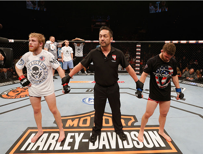 LAS VEGAS, NV - JULY 06:  (L-R) Justin Scoggins and Dustin Ortiz wait for the final decision in their flyweight fight during the Ultimate Fighter Finale inside the Mandalay Bay Events Center on July 6, 2014 in Las Vegas, Nevada.  (Photo by Josh Hedges/Zuf