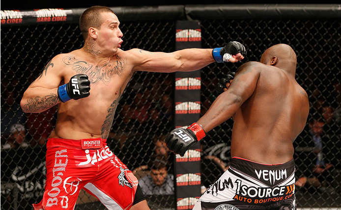 LAS VEGAS, NV - JULY 06:  (L-R) Guto Inocente punches Derrick Lewis in their heavyweight fight during the Ultimate Fighter Finale inside the Mandalay Bay Events Center on July 6, 2014 in Las Vegas, Nevada.  (Photo by Josh Hedges/Zuffa LLC/Zuffa LLC via Ge