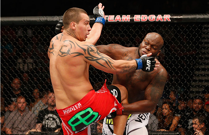 LAS VEGAS, NV - JULY 06: (R-L) Derrick Lewis punches Guto Inocente in their heavyweight fight during the Ultimate Fighter Finale inside the Mandalay Bay Events Center on July 6, 2014 in Las Vegas, Nevada. (Photo by Josh Hedges/Zuffa LLC/Zuffa LLC via Ge