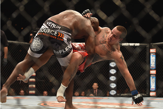 LAS VEGAS, NV - JULY 06:  (L-R) Derrick Lewis takes down Guto Inocente in their middleweight fight during the Ultimate Fighter Finale inside the Mandalay Bay Events Center on July 6, 2014 in Las Vegas, Nevada.  (Photo by Jeff Bottari/Zuffa LLC/Zuffa LLC v