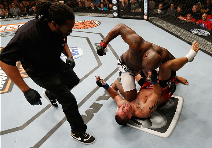 LAS VEGAS, NV - JULY 06:  Derrick Lewis (top) punches Guto Inocente in their heavyweight fight during the Ultimate Fighter Finale inside the Mandalay Bay Events Center on July 6, 2014 in Las Vegas, Nevada.  (Photo by Josh Hedges/Zuffa LLC/Zuffa LLC via Ge