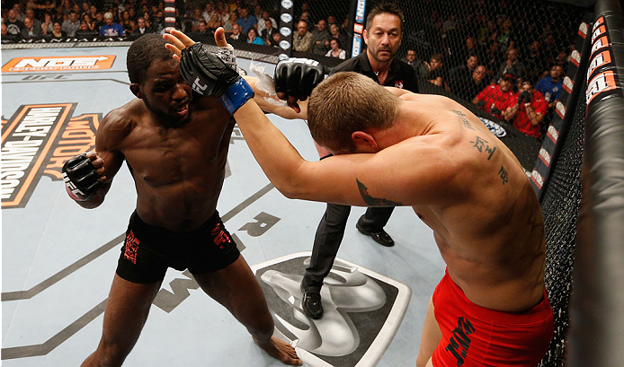 LAS VEGAS, NV - JULY 06:  (L-R) Corey Anderson punches Matt Van Buren in their light heavyweight fight during the Ultimate Fighter Finale inside the Mandalay Bay Events Center on July 6, 2014 in Las Vegas, Nevada.  (Photo by Josh Hedges/Zuffa LLC/Zuffa LL