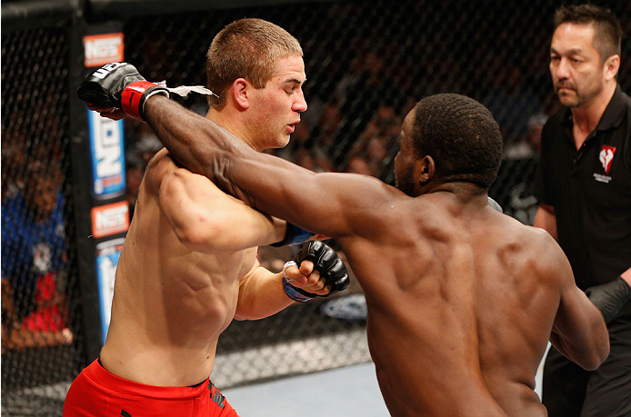 LAS VEGAS, NV - JULY 06: (R-L) Corey Anderson punches Matt Van Buren in their light heavyweight fight during the Ultimate Fighter Finale inside the Mandalay Bay Events Center on July 6, 2014 in Las Vegas, Nevada. (Photo by Josh Hedges/Zuffa LLC/Zuffa LL