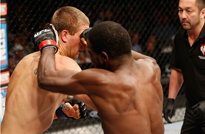LAS VEGAS, NV - JULY 06: (R-L) Corey Anderson punches Matt Van Buren in their light heavyweight fight during the Ultimate Fighter Finale inside the Mandalay Bay Events Center on July 6, 2014 in Las Vegas, Nevada. (Photo by Josh Hedges/Zuffa LLC/Zuffa LL