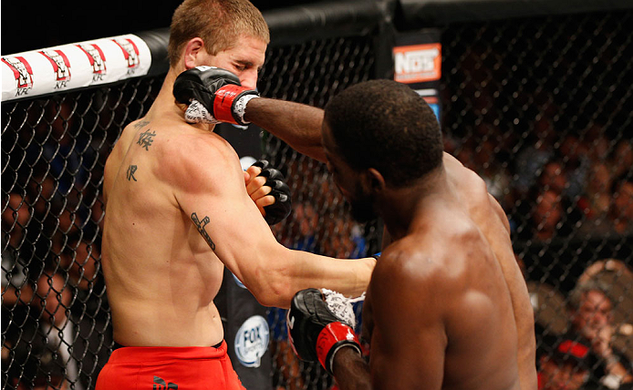 LAS VEGAS, NV - JULY 06: (R-L) Corey Anderson punches Matt Van Buren in their light heavyweight fight during the Ultimate Fighter Finale inside the Mandalay Bay Events Center on July 6, 2014 in Las Vegas, Nevada. (Photo by Josh Hedges/Zuffa LLC/Zuffa LL