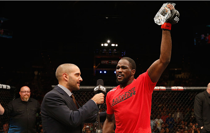LAS VEGAS, NV - JULY 06: (L-R) Jon Anik interviews The Ultimate Fighter season 19 light heavyweight winner Corey Anderson after his fight against Matt Van Buren during the Ultimate Fighter Finale inside the Mandalay Bay Events Center on July 6, 2014 in L