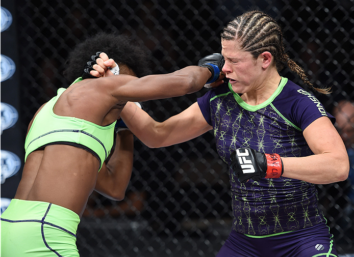 LAS VEGAS, NEVADA - DECEMBER 12: (L-R) Angela Hill punches Emily Kagan in their strawweight fight during The Ultimate Fighter Finale event inside the Pearl concert theater at the Palms Casino Resort on December 12, 2014 in Las Vegas, Nevada. (Photo by Jef