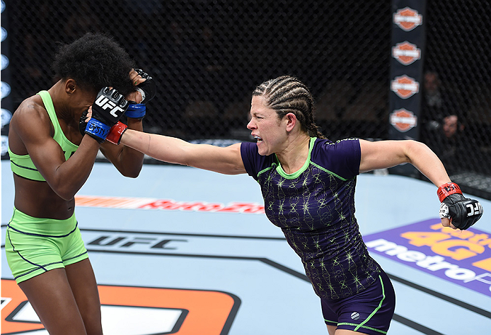 LAS VEGAS, NEVADA - DECEMBER 12: (R-L) Emily Kagan punches Angela Hill in their strawweight fight during The Ultimate Fighter Finale event inside the Pearl concert theater at the Palms Casino Resort on December 12, 2014 in Las Vegas, Nevada. (Photo by Jef