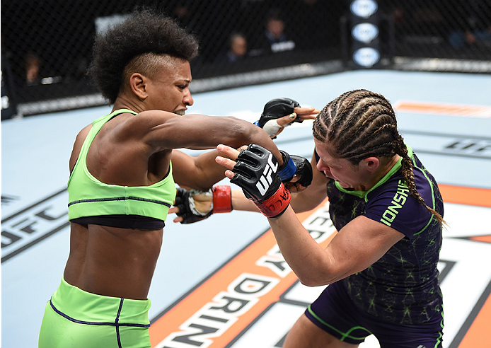 LAS VEGAS, NEVADA - DECEMBER 12: (L-R) Angela Hill punches Emily Kagan in their strawweight fight during The Ultimate Fighter Finale event inside the Pearl concert theater at the Palms Casino Resort on December 12, 2014 in Las Vegas, Nevada. (Photo by Jef