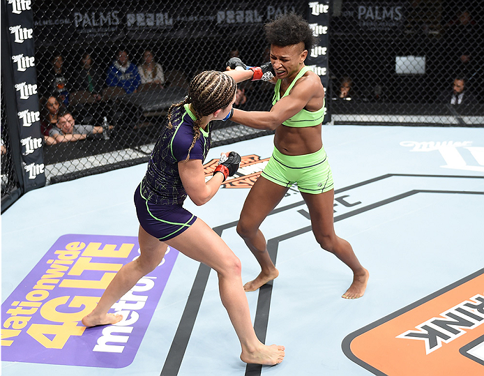 LAS VEGAS, NEVADA - DECEMBER 12: (L-R) Emily Kagan punches Angela Hill in their strawweight fight during The Ultimate Fighter Finale event inside the Pearl concert theater at the Palms Casino Resort on December 12, 2014 in Las Vegas, Nevada. (Photo by Jef