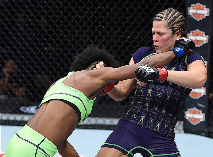 LAS VEGAS, NEVADA - DECEMBER 12: (L-R) Angela Hill punches Emily Kagan in their strawweight fight during The Ultimate Fighter Finale event inside the Pearl concert theater at the Palms Casino Resort on December 12, 2014 in Las Vegas, Nevada. (Photo by Jef