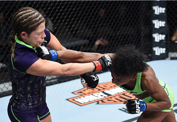 LAS VEGAS, NEVADA - DECEMBER 12: (R-L) Angela Hill punches Emily Kagan in their strawweight fight during The Ultimate Fighter Finale event inside the Pearl concert theater at the Palms Casino Resort on December 12, 2014 in Las Vegas, Nevada. (Photo by Jef