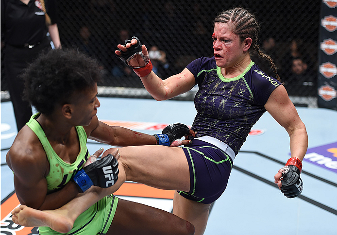 LAS VEGAS, NEVADA - DECEMBER 12: (R-L) Emily Kagan kickss Angela Hill in their strawweight fight during The Ultimate Fighter Finale event inside the Pearl concert theater at the Palms Casino Resort on December 12, 2014 in Las Vegas, Nevada. (Photo by Jeff