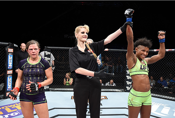 LAS VEGAS, NEVADA - DECEMBER 12: (R-L) Angela Hill celebrates her victory over Emily Kagan in their strawweight fight during The Ultimate Fighter Finale event inside the Pearl concert theater at the Palms Casino Resort on December 12, 2014 in Las Vegas, N