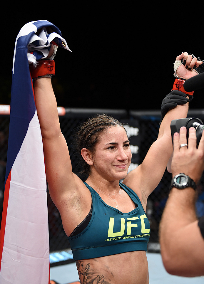 LAS VEGAS, NEVADA - DECEMBER 12: Tecia Torres celebrates her victory over Angela Magana in their strawweight fight during The Ultimate Fighter Finale event inside the Pearl concert theater at the Palms Casino Resort on December 12, 2014 in Las Vegas, Nev