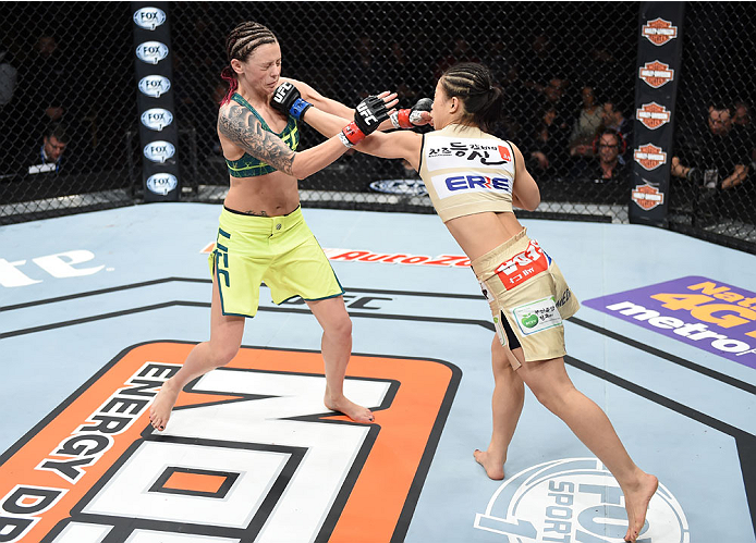 LAS VEGAS, NEVADA - DECEMBER 12: (R-L) Seohee Ham punches Joanne Calderwood in their strawweight fight during The Ultimate Fighter Finale event inside the Palms Casino Resort on December 12, 2014 in Las Vegas, Nevada. (Photo by Jeff Bottari/Zuffa LLC/Zuff