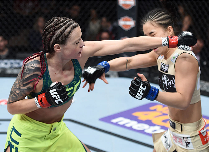 LAS VEGAS, NEVADA - DECEMBER 12: (L-R) Joanne Calderwood punches Seohee Ham in their strawweight fight during The Ultimate Fighter Finale event inside the Palms Casino Resort on December 12, 2014 in Las Vegas, Nevada. (Photo by Jeff Bottari/Zuffa LLC/Zuff