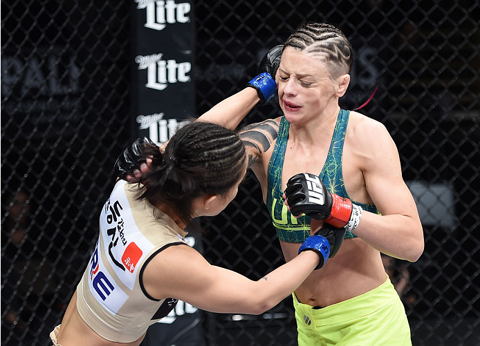 LAS VEGAS, NEVADA - DECEMBER 12: (L-R) Seohee Ham punches Joanne Calderwood in their strawweight fight during The Ultimate Fighter Finale event inside the Palms Casino Resort on December 12, 2014 in Las Vegas, Nevada. (Photo by Jeff Bottari/Zuffa LLC/Zuff