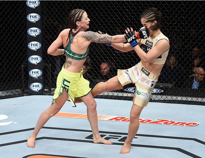 LAS VEGAS, NEVADA - DECEMBER 12: (L-R) Joanne Calderwood punches Seohee Ham in their strawweight fight during The Ultimate Fighter Finale event inside the Palms Casino Resort on December 12, 2014 in Las Vegas, Nevada. (Photo by Jeff Bottari/Zuffa LLC/Zuff