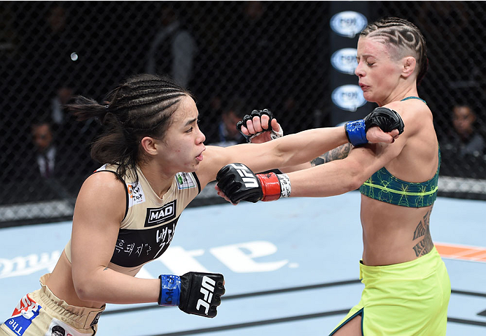 LAS VEGAS, NEVADA - DECEMBER 12: (L-R) Seohee Ham punches Joanne Calderwood in their strawweight fight during The Ultimate Fighter Finale event inside the Palms Casino Resort on December 12, 2014 in Las Vegas, Nevada. (Photo by Jeff Bottari/Zuffa LLC/Zuff