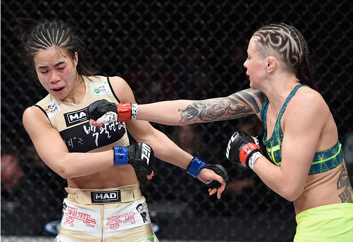 LAS VEGAS, NEVADA - DECEMBER 12: (R-L) Joanne Calderwood punches Seohee Ham in their strawweight fight during The Ultimate Fighter Finale event inside the Palms Casino Resort on December 12, 2014 in Las Vegas, Nevada. (Photo by Jeff Bottari/Zuffa LLC/Zuff