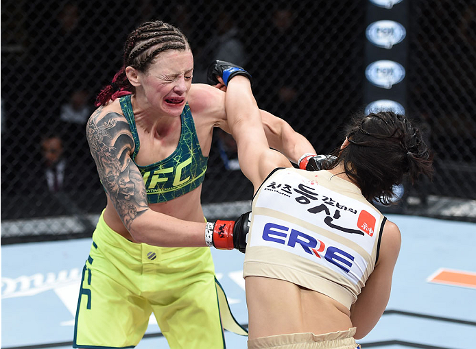 LAS VEGAS, NEVADA - DECEMBER 12: (R-L) Seohee Ham punches Joanne Calderwood in their strawweight fight during The Ultimate Fighter Finale event inside the Palms Casino Resort on December 12, 2014 in Las Vegas, Nevada. (Photo by Jeff Bottari/Zuffa LLC/Zuff
