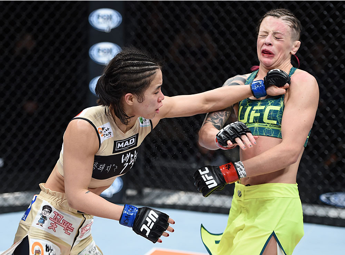 LAS VEGAS, NEVADA - DECEMBER 12: (L-R) Seohee Ham punches Joanne Calderwood in their strawweight fight during The Ultimate Fighter Finale event inside the Palms Casino Resort on December 12, 2014 in Las Vegas, Nevada. (Photo by Jeff Bottari/Zuffa LLC/Zuff