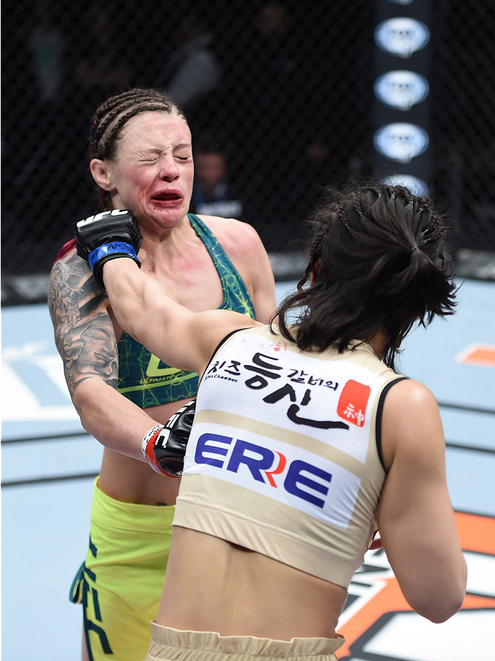 LAS VEGAS, NEVADA - DECEMBER 12: (R-L) Seohee Ham punches Joanne Calderwood in their strawweight fight during The Ultimate Fighter Finale event inside the Palms Casino Resort on December 12, 2014 in Las Vegas, Nevada. (Photo by Jeff Bottari/Zuffa LLC/Zuff