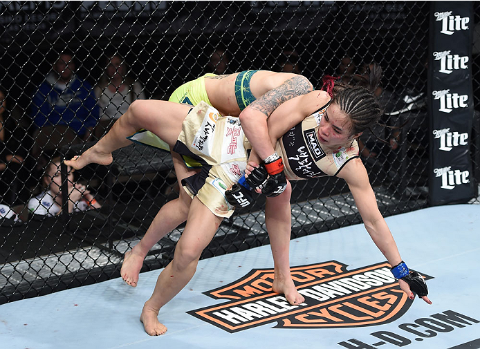 LAS VEGAS, NEVADA - DECEMBER 12: (R-L) Joanne Calderwood takes down Seohee Ham in their strawweight fight during The Ultimate Fighter Finale event inside the Palms Casino Resort on December 12, 2014 in Las Vegas, Nevada. (Photo by Jeff Bottari/Zuffa LLC/Z