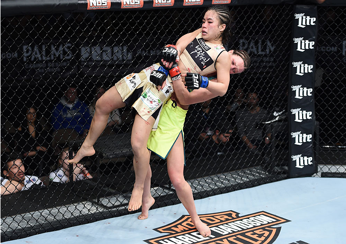 LAS VEGAS, NEVADA - DECEMBER 12: (R-L) Joanne Calderwood takes down Seohee Ham in their strawweight fight during The Ultimate Fighter Finale event inside the Palms Casino Resort on December 12, 2014 in Las Vegas, Nevada. (Photo by Jeff Bottari/Zuffa LLC/Z