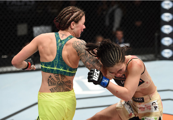 LAS VEGAS, NEVADA - DECEMBER 12: (L-R) Joanne Calderwood lands a spinning back elbow on Seohee Ham in their strawweight fight during The Ultimate Fighter Finale event inside the Palms Casino Resort on December 12, 2014 in Las Vegas, Nevada. (Photo by Jeff