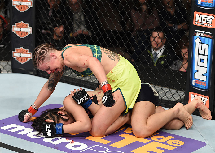 LAS VEGAS, NEVADA - DECEMBER 12: Joanne Calderwood (top) punches Seohee Ham in their strawweight fight during The Ultimate Fighter Finale event inside the Palms Casino Resort on December 12, 2014 in Las Vegas, Nevada. (Photo by Jeff Bottari/Zuffa LLC/Zuff