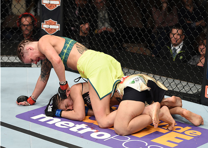 LAS VEGAS, NEVADA - DECEMBER 12: Joanne Calderwood (top) punches Seohee Ham in their strawweight fight during The Ultimate Fighter Finale event inside the Palms Casino Resort on December 12, 2014 in Las Vegas, Nevada. (Photo by Jeff Bottari/Zuffa LLC/Zuff