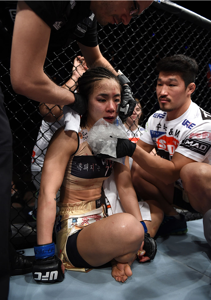 LAS VEGAS, NEVADA - DECEMBER 12: Seohee Ham gets iced by her team after her fight against Joanne Calderwood in their strawweight fight during The Ultimate Fighter Finale event inside the Palms Casino Resort on December 12, 2014 in Las Vegas, Nevada. (Pho