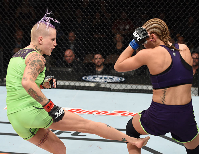 LAS VEGAS, NEVADA - DECEMBER 12: (L-R) Bec Rawlings kicks Heather Jo Clark in their strawweight fight during The Ultimate Fighter Finale event inside the Pearl concert theater at the Palms Casino Resort on December 12, 2014 in Las Vegas, Nevada. (Photo by