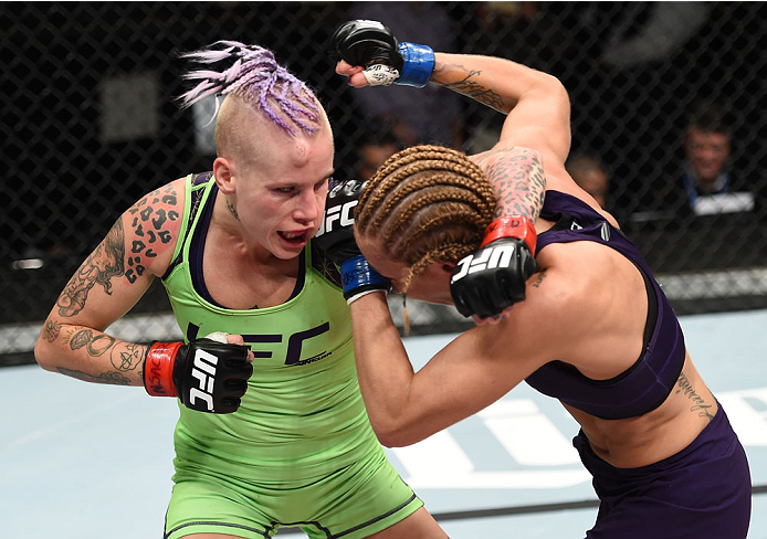 LAS VEGAS, NEVADA - DECEMBER 12: (L-R) Bec Rawlings exchanges punches with Heather Jo Clark in their strawweight fight during The Ultimate Fighter Finale event inside the Pearl concert theater at the Palms Casino Resort on December 12, 2014 in Las Vegas,