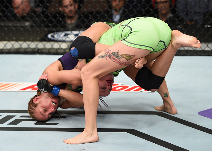 LAS VEGAS, NEVADA - DECEMBER 12: Heather Jo Clark (top) attempts to submit Bec Rawlings in their strawweight fight during The Ultimate Fighter Finale event inside the Pearl concert theater at the Palms Casino Resort on December 12, 2014 in Las Vegas, Neva