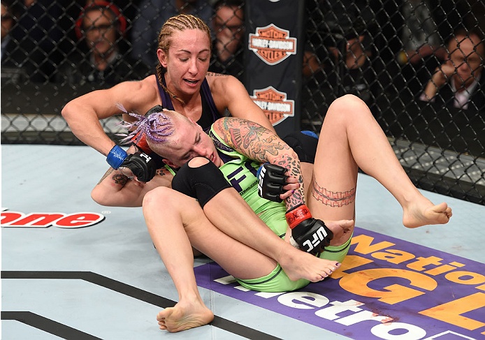 LAS VEGAS, NEVADA - DECEMBER 12: Heather Jo Clark punches Bec Rawlings in their strawweight fight during The Ultimate Fighter Finale event inside the Pearl concert theater at the Palms Casino Resort on December 12, 2014 in Las Vegas, Nevada. (Photo by Jef