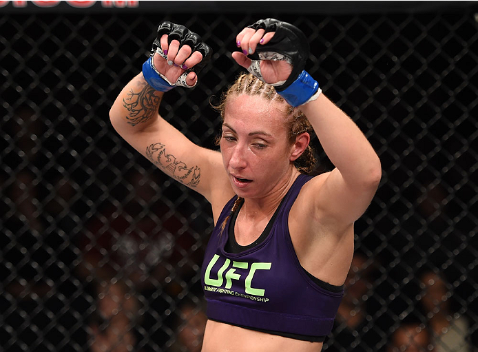 LAS VEGAS, NEVADA - DECEMBER 12: Heather Jo Clark raises her hands in-between rounds during her fight against Bec Rawlings in their strawweight fight during The Ultimate Fighter Finale event inside the Pearl concert theater at the Palms Casino Resort on D