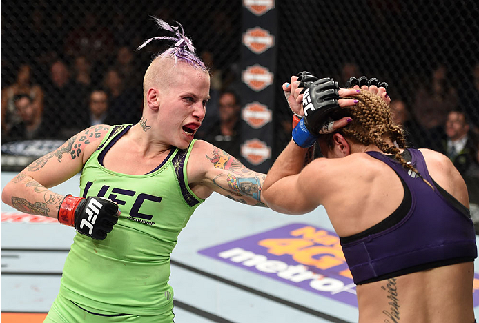 LAS VEGAS, NEVADA - DECEMBER 12: (L-R) Bec Rawlings punches Heather Jo Clark in their strawweight fight during The Ultimate Fighter Finale event inside the Pearl concert theater at the Palms Casino Resort on December 12, 2014 in Las Vegas, Nevada. (Photo