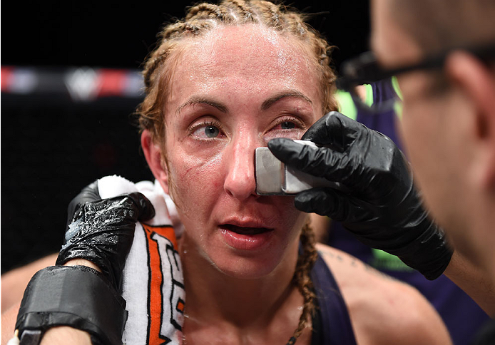 LAS VEGAS, NEVADA - DECEMBER 12: Heather Jo Clark gets looked at by the cut man after her fight against Bec Rawlings in their strawweight fight during The Ultimate Fighter Finale event inside the Pearl concert theater at the Palms Casino Resort on Decembe